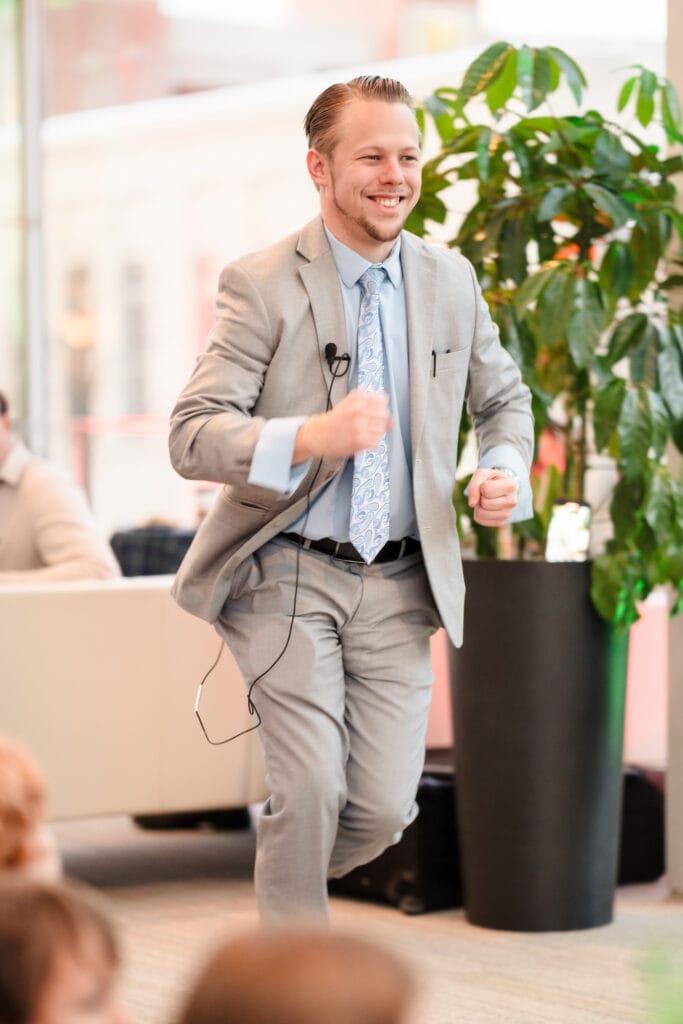 Magician Ryan Martin jogging onto stage