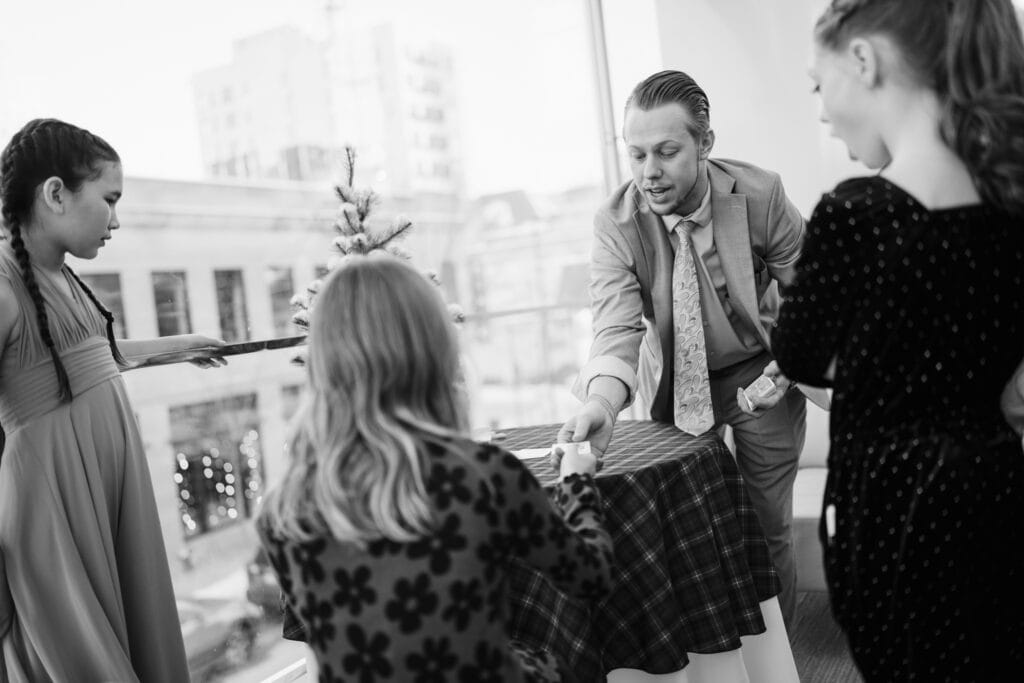 Magician Ryan Martin handing a woman a playing card
