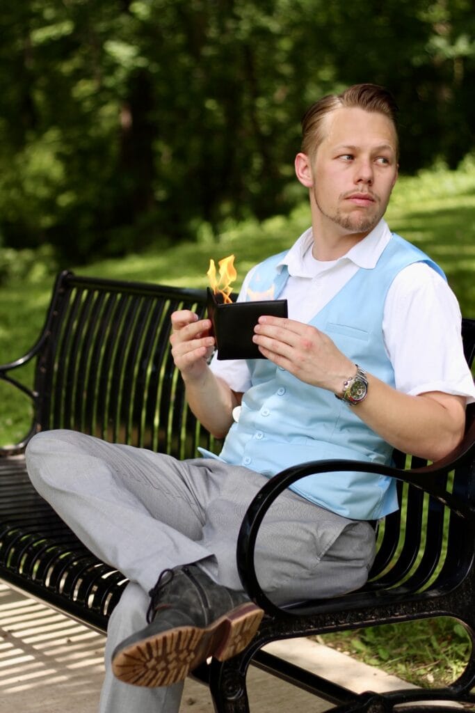 Ryan holding burning wallet